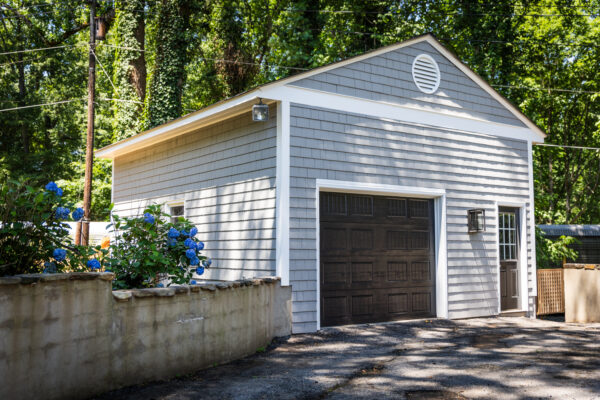 Garage apartment painted gray with black and white accents.