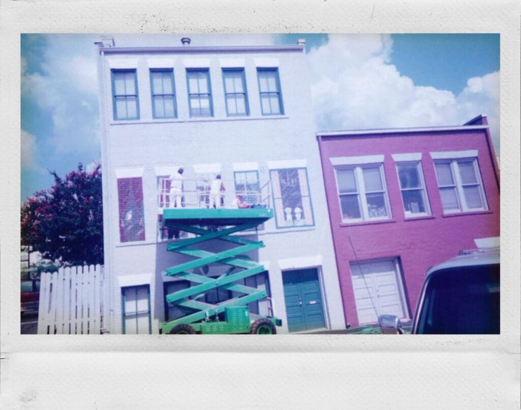 Polaroid of IPC workers in the past working on a building exterior in downtown Spartanburg, SC.